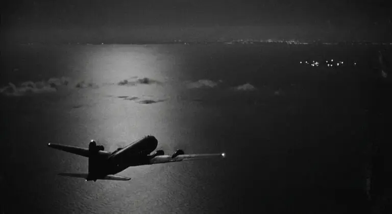 1952 airliner over bay, distant lights