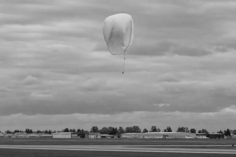 Deflating Weather Balloon in Open Sky